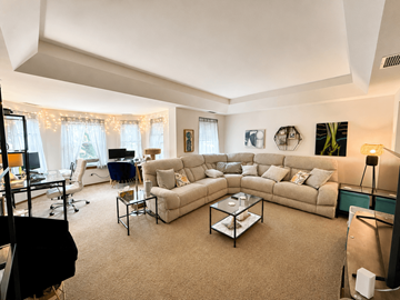 Chicago apartment for rent - A living room with a large couch and a coffee table.