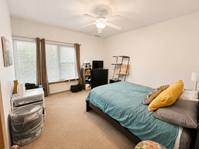 Chicago apartment for rent - A bedroom with a bed, dresser, and window.