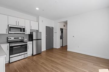 Denver apartment for rent - A kitchen with white cabinets and stainless steel appliances.