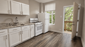 Chicago apartment for rent - A kitchen with white cabinets and a wooden floor.