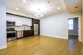 Chicago apartment for rent - A kitchen with wooden floors and white walls.