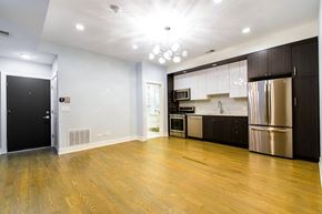 Chicago apartment for rent - A kitchen with wooden floors and stainless steel appliances.