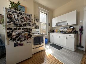 Chicago apartment for rent - A kitchen with a refrigerator covered in photos.
