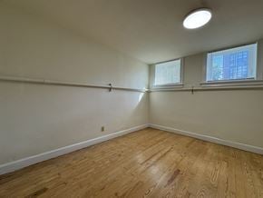 Chicago apartment for rent - A room with wooden flooring and a window.
