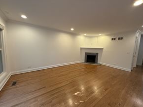 Winnetka townhouse for rent - A room with a fireplace and wooden flooring.