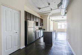 Chicago apartment for rent - A kitchen with a refrigerator, oven, and cabinets.