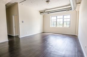 Chicago apartment for rent - A room with wooden floors and a window.