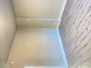 Chicago apartment for rent - A bathroom with a wooden wall and a white floor.