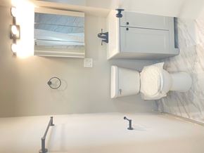 Chicago apartment for rent - A white bathroom with a toilet and a mirror.