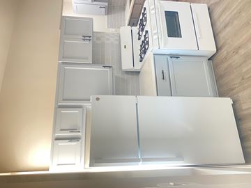 Chicago apartment for rent - A kitchen with white appliances and cabinets.