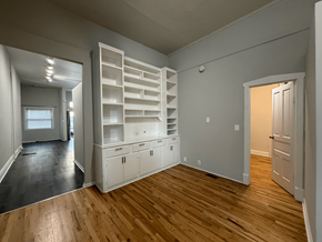 Chicago apartment for rent - A room with wooden floors and white walls.