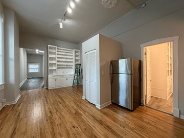 Chicago apartment for rent - A kitchen with a refrigerator and wooden floors.