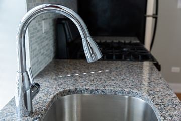 Chicago apartment for rent - A kitchen sink with a chrome faucet.