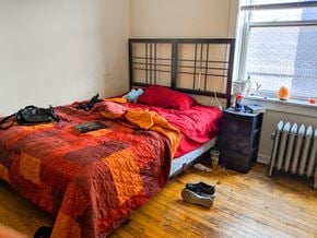 Chicago apartment for rent - a bedroom with a bed and shoes on the floor