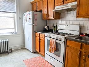 Chicago apartment for rent - a kitchen with a stove and refrigerator and wooden cabinets