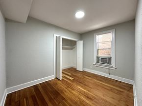 Chicago apartment for rent - A room with a wooden floor and a window.