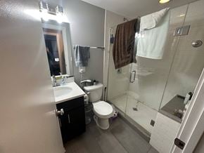 Chicago apartment for rent - A bathroom with a toilet, sink, and shower.