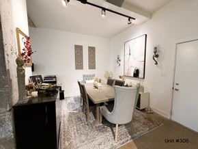 Chicago apartment for rent - A dining room with a table set for two and a decorative mirror on the wall.