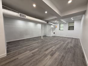 Chicago apartment for rent - A room with wooden flooring and white walls.