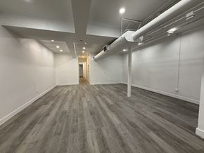 Chicago apartment for rent - A room with a grey floor and white walls.