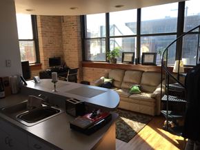 Chicago apartment for rent - A kitchen with a couch and a table.