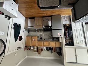 Chicago apartment for rent - A small kitchen with a microwave, oven, and refrigerator.