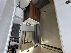 Chicago apartment for rent - A bathroom with a white sink and a mirror.