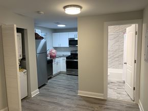 Chicago apartment for rent - A kitchen with a refrigerator, oven, and cabinets.