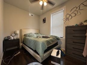 Chicago apartment for rent - A bedroom with a bed, nightstand, and window.