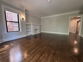 Chicago apartment for rent - A room with wooden floors and a window.