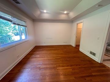 Winnetka townhouse for rent - A room with wooden floors and white walls.