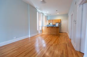 Chicago apartment for rent - A kitchen with wooden floors and white walls.