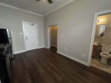 Chicago apartment for rent - A kitchen with a stove top oven and a white door.