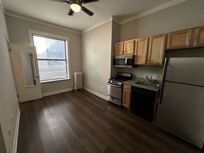 Chicago apartment for rent - A kitchen with a refrigerator, stove, and microwave.