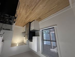 Chicago apartment for rent - A kitchen with a black stove top oven and white cabinets.