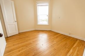 Chicago apartment for rent - an empty room with wooden floors and a window