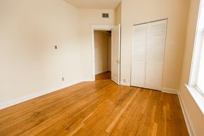 Chicago apartment for rent - an empty living room with wood floors and a closet