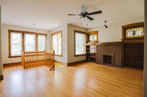 Chicago apartment for rent - A living room with a fireplace and a fan.