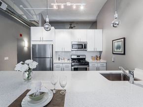 Chicago apartment for rent - a white kitchen with stainless steel appliances and white counter tops