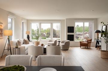 Rocky River townhouse for rent - A modern living room with white furniture and a large window.