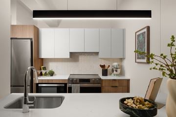 Chicago apartment for rent - A modern kitchen with a stainless steel refrigerator and a bowl of fruit on the counter.
