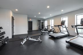 Chicago apartment for rent - A spacious gym with treadmills, elliptical machines, and weight benches.