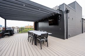 Chicago apartment for rent - A black building with a white table and chairs in front.