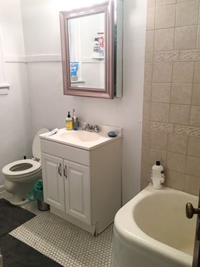 Evanston apartment for rent - A white bathroom with a toilet, sink, and bathtub.