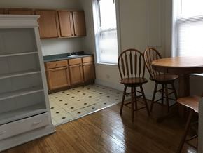 Chicago apartment for rent - A kitchen with wooden floors and a checkered floor.