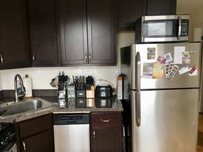 Chicago apartment for rent - A kitchen with a stainless steel refrigerator and a microwave above it.