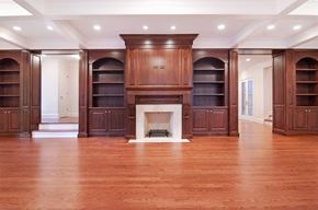 Chicago apartment for rent - A large room with a fireplace and wooden floors.