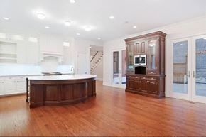 Chicago apartment for rent - A kitchen with a wooden floor and white walls.