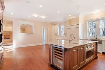 Chicago apartment for rent - A kitchen with wooden cabinets and a large island.