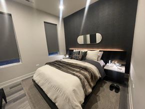 Chicago apartment for rent - A bedroom with a bed, nightstand, and window.